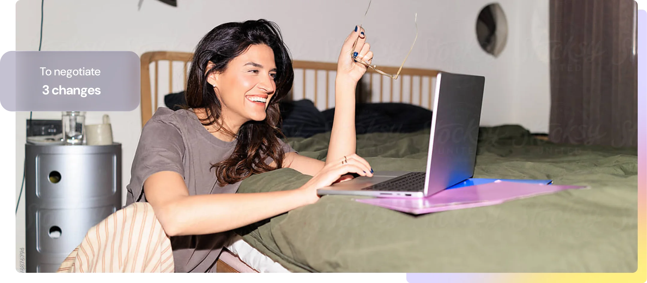 A woman smiling at her laptop at home, with three contract changes to negotiate